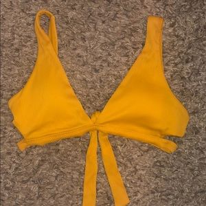 Great condition. Bathing suit is a yellow/orange